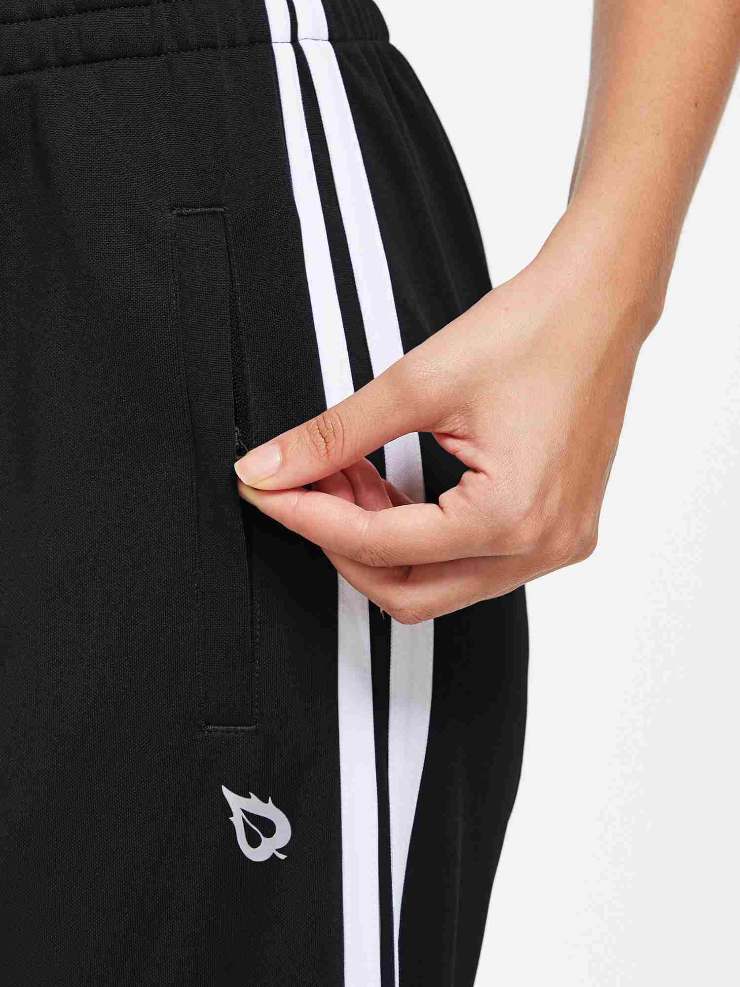 Knit straight-leg running pants in black with white side stripes and zippered pocket. #color_Black/White