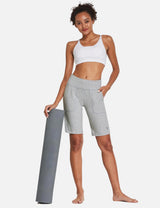 Laureate High Rise Bermuda Shorts in light gray, model holding yoga mat. #color_Light Gray