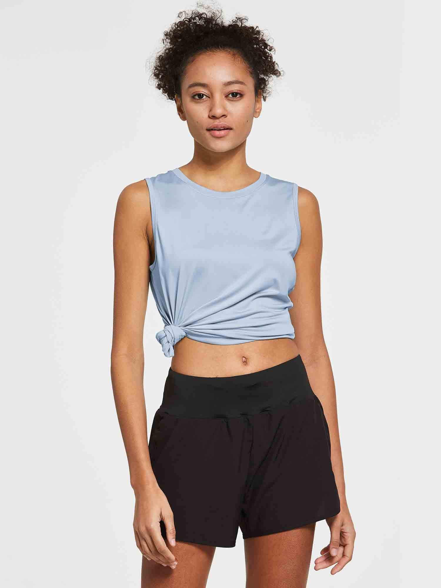 Women's light blue sleeveless workout tank top, crew neck, knotted side detail, black shorts. #color_Kentucky Blue