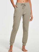 Women's khaki tapered cotton sweatpants with drawstring waist and pockets. #color_Khaki