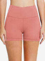 Women's 5-inch high-waisted compression biker shorts in pink with side pockets. #color_Coral Red