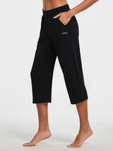 Woman in black Baleaf lightweight wide-leg cotton capri pants with drawstring and pockets. #color_Black