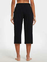Woman's back view of black wide-leg cotton capri pants with pockets. #color_Black