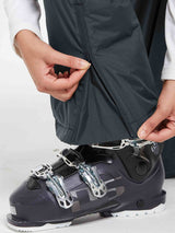 Dark grey waterproof ski bib pants zipper detail with ski boot
