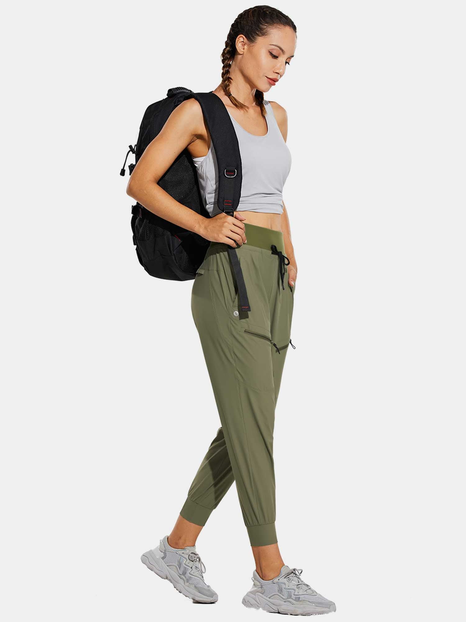 Woman wearing olive green high-waisted quick-dry hiking joggers and backpack. #color_Light Green