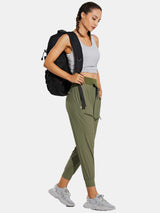 Woman wearing olive green high-waisted quick-dry hiking joggers and backpack. #color_Light Green