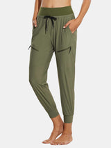 Women's high-waisted quick-dry joggers in olive green with zip pockets.