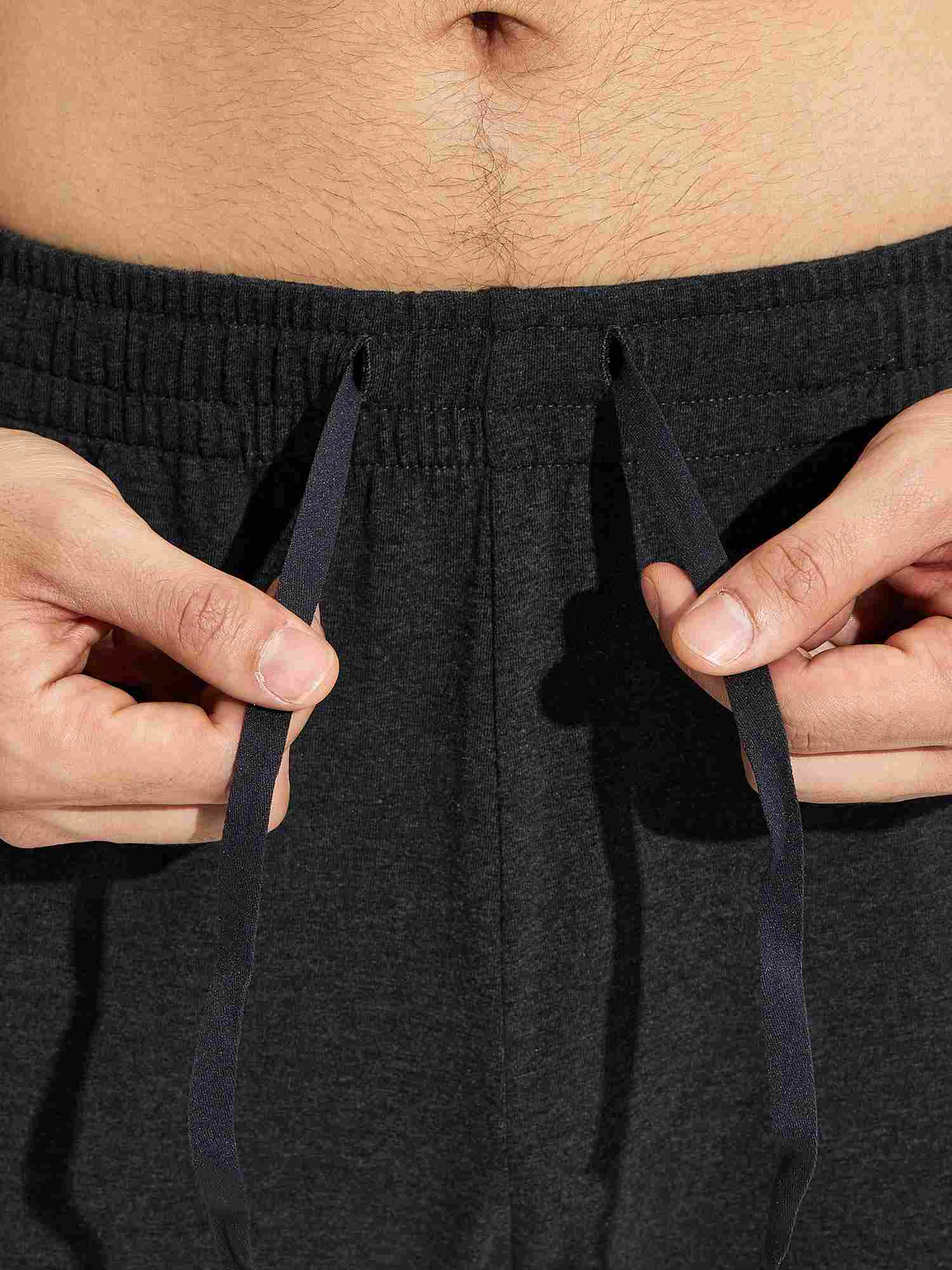 Close-up of hands adjusting navy drawstring on dark gray men's cotton yoga cargo pants waistband #color_Dark Gray