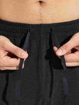 Close-up of hands adjusting navy drawstring on dark gray men's cotton yoga cargo pants waistband #color_Dark Gray