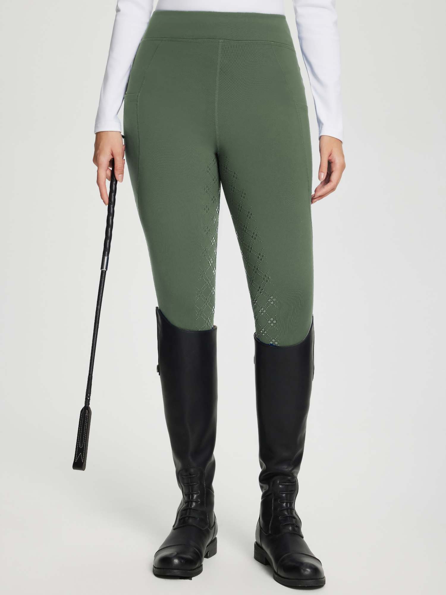 Women's full seat silicone breeches in olive green, with textured pattern and black boots. #color_Army Green