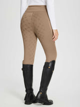 Women's tan full seat equestrian breeches with diamond laser-cut pattern and back zip pocket. #color_Brown