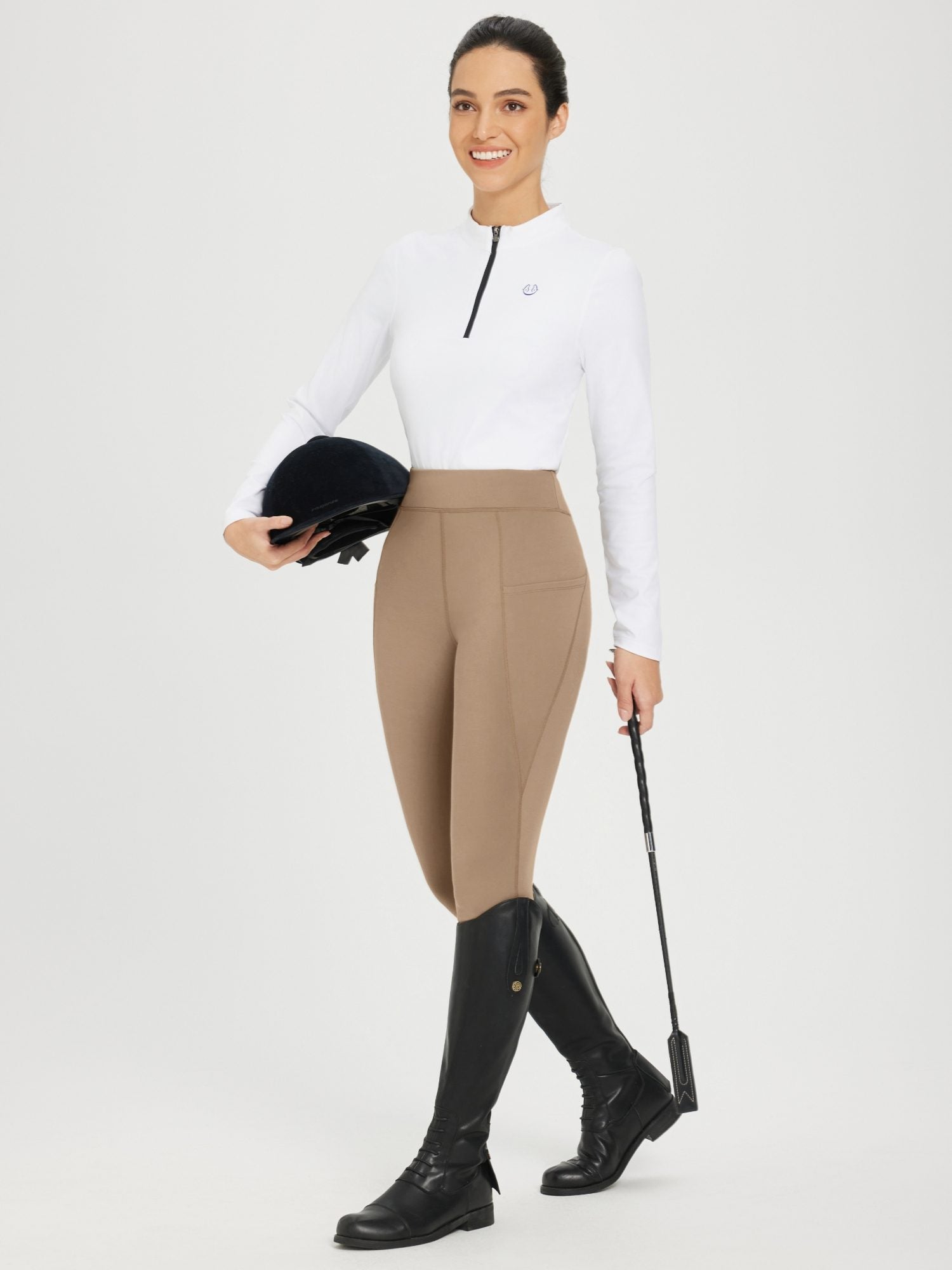 Women's tan full-seat silicone breeches with fleece lining, white shirt, black boots. #color_Brown