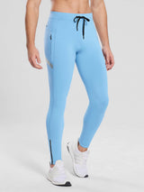 Men's light blue fleece-lined cycling tights with zippered pockets and reflective ankle stripe.