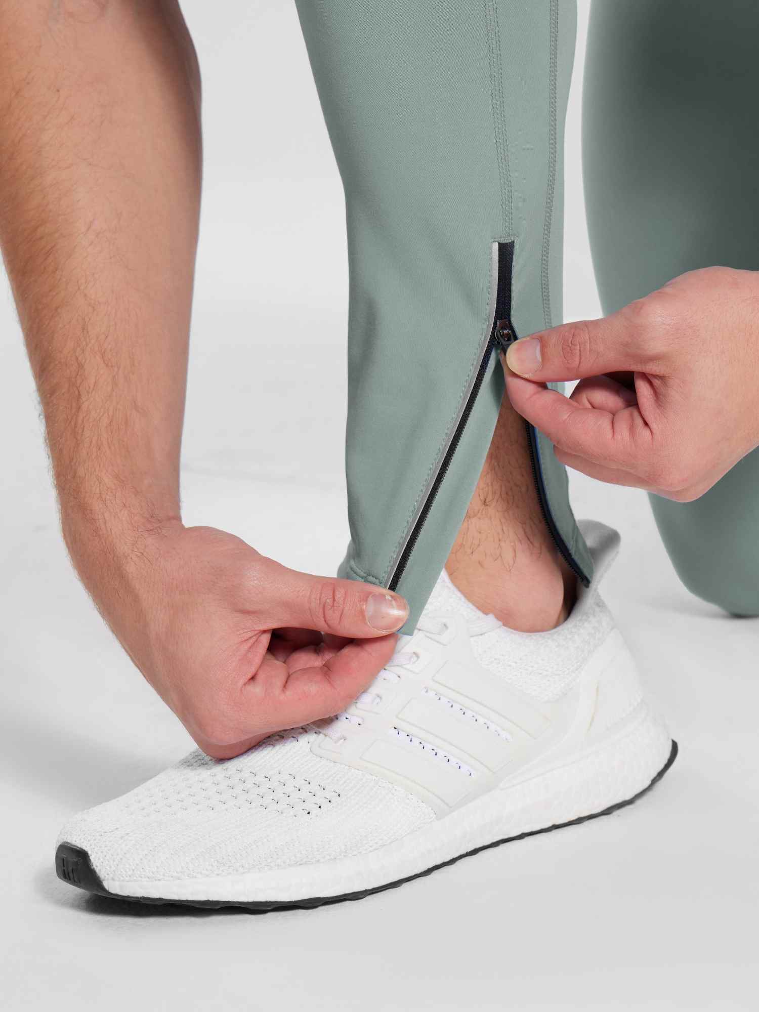 Men's 30" mint green fleece-lined cycling tights, showing ankle zipper detail. #color_Gray