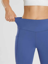 Stretchy blue women's fleece-lined cycling leggings with side pocket and V-seam detail. #color_Navy Blue