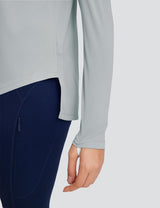 Light gray loose crew neck long sleeve t-shirt with split hem paired with navy leggings with zippered pocket