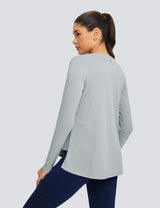Light gray loose crew neck long sleeve t-shirt with a relaxed fit and hip-length coverage, paired with navy blue leggings.