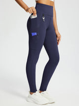Women's navy knit fleece leggings with high waist, side pockets holding phone & card, key loop.