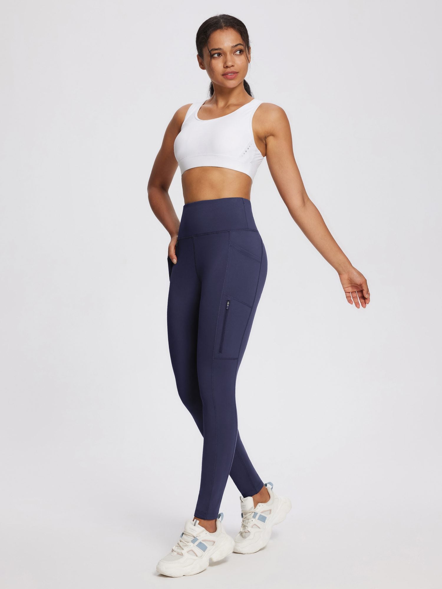 Women's navy high-rise knit fleece leggings with zippered side pocket.