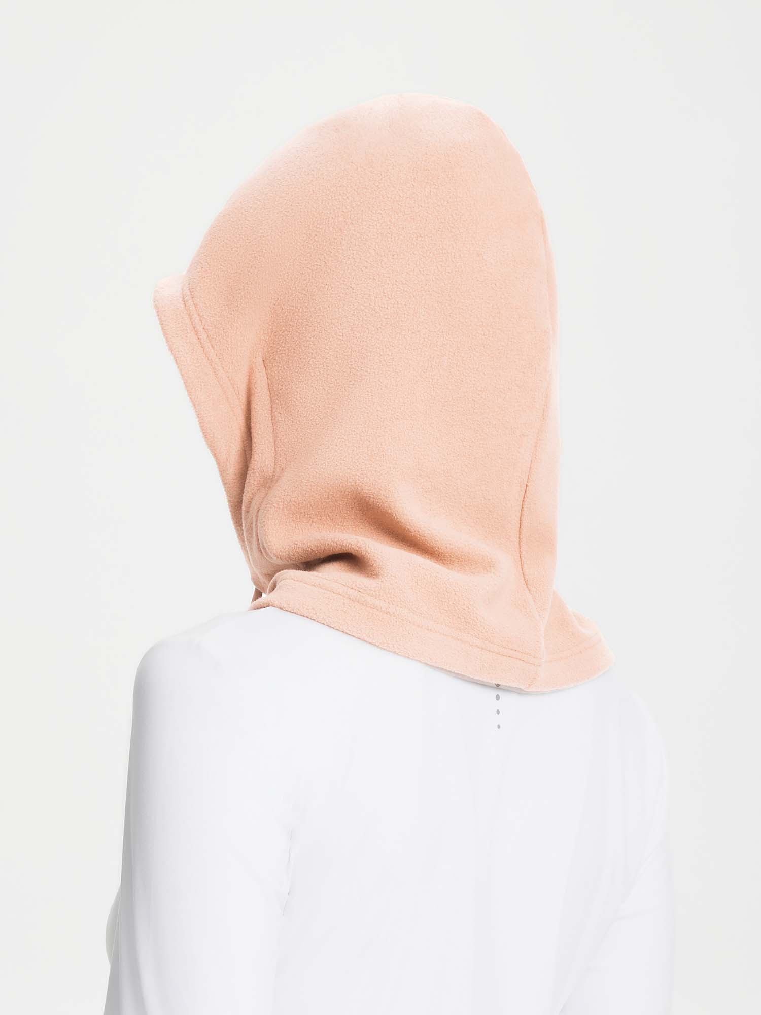 Unisex adjustable fleece ski hat in soft peach color, designed for warmth and outdoor use.