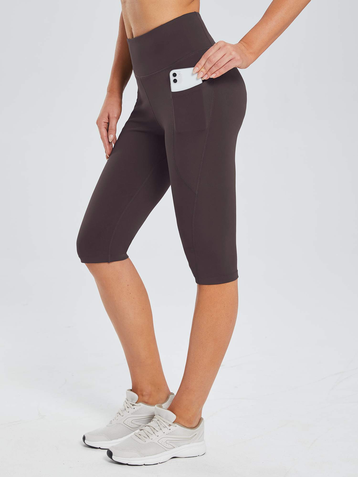 Plus size dark brown knee-length capris with pockets for phone, athletic wear. #color_Dark Brown