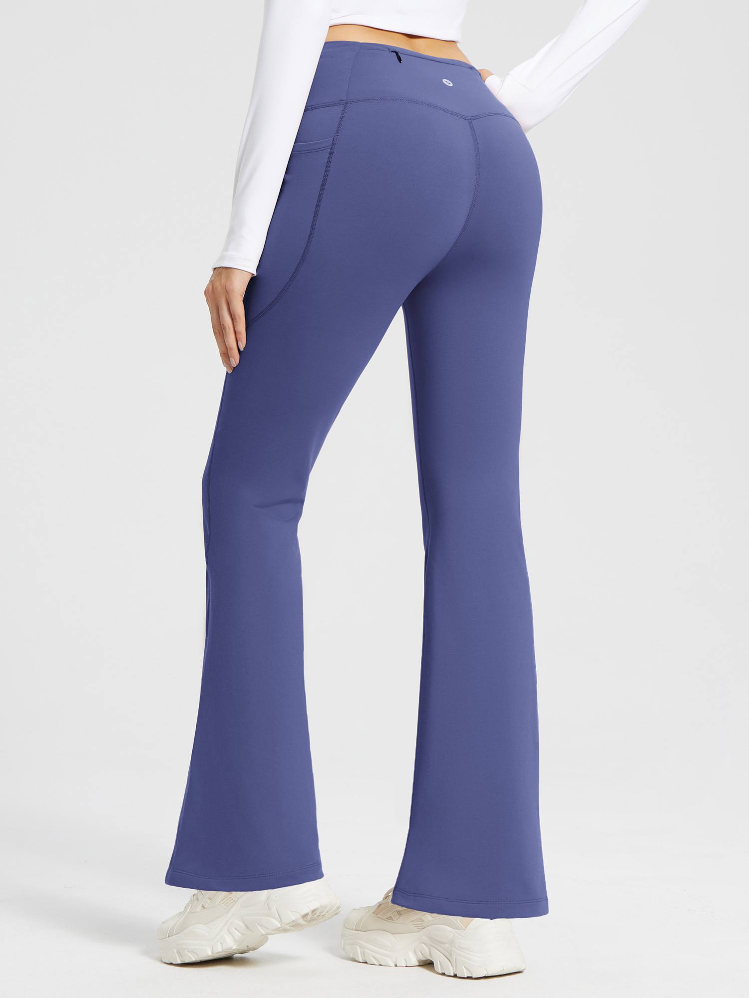 Blue high-waist fleece-lined flare pants with pockets and V-back design. #color_Navy Blue