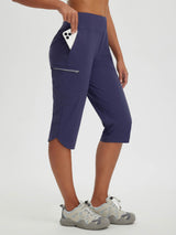 Women's navy 17" capris for hiking/cycling: quick-dry fabric, secure zipper pockets holding phone. #color_Navy Blue
