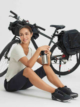 Women in navy women's 17 inch capris for cycling and hiking, by bike. #color_Black