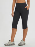 Women's black capri pants for cycling and hiking, featuring pockets and curved hem. #color_Black