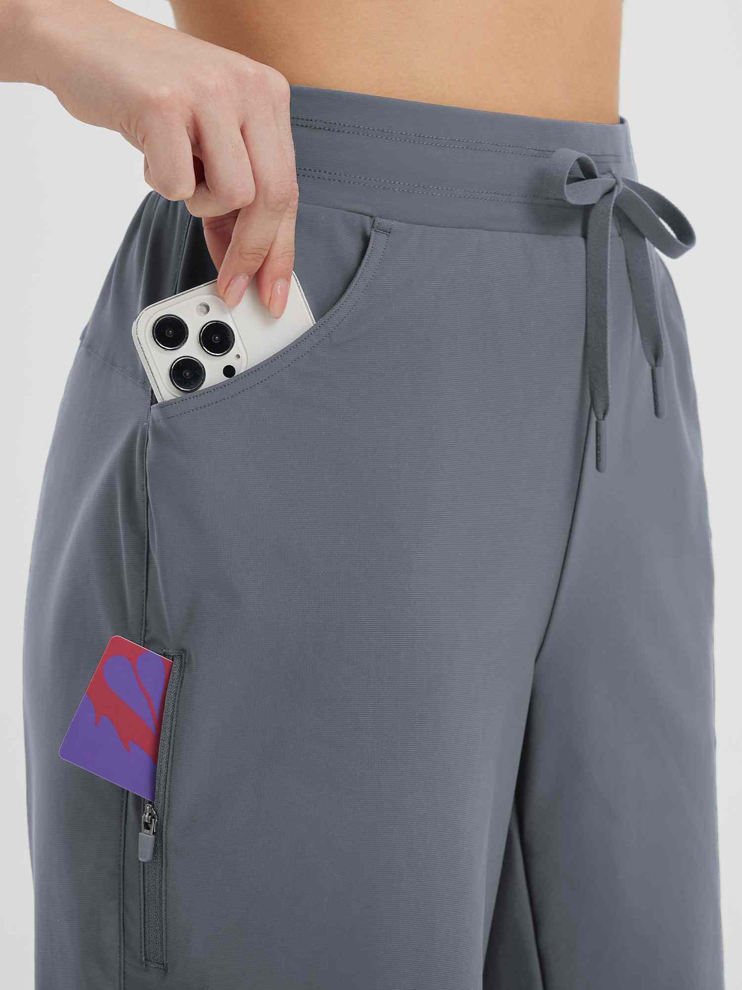 Women's grey 9" cycling shorts with phone in side pocket and zippered thigh pocket. #color_Dark Gray