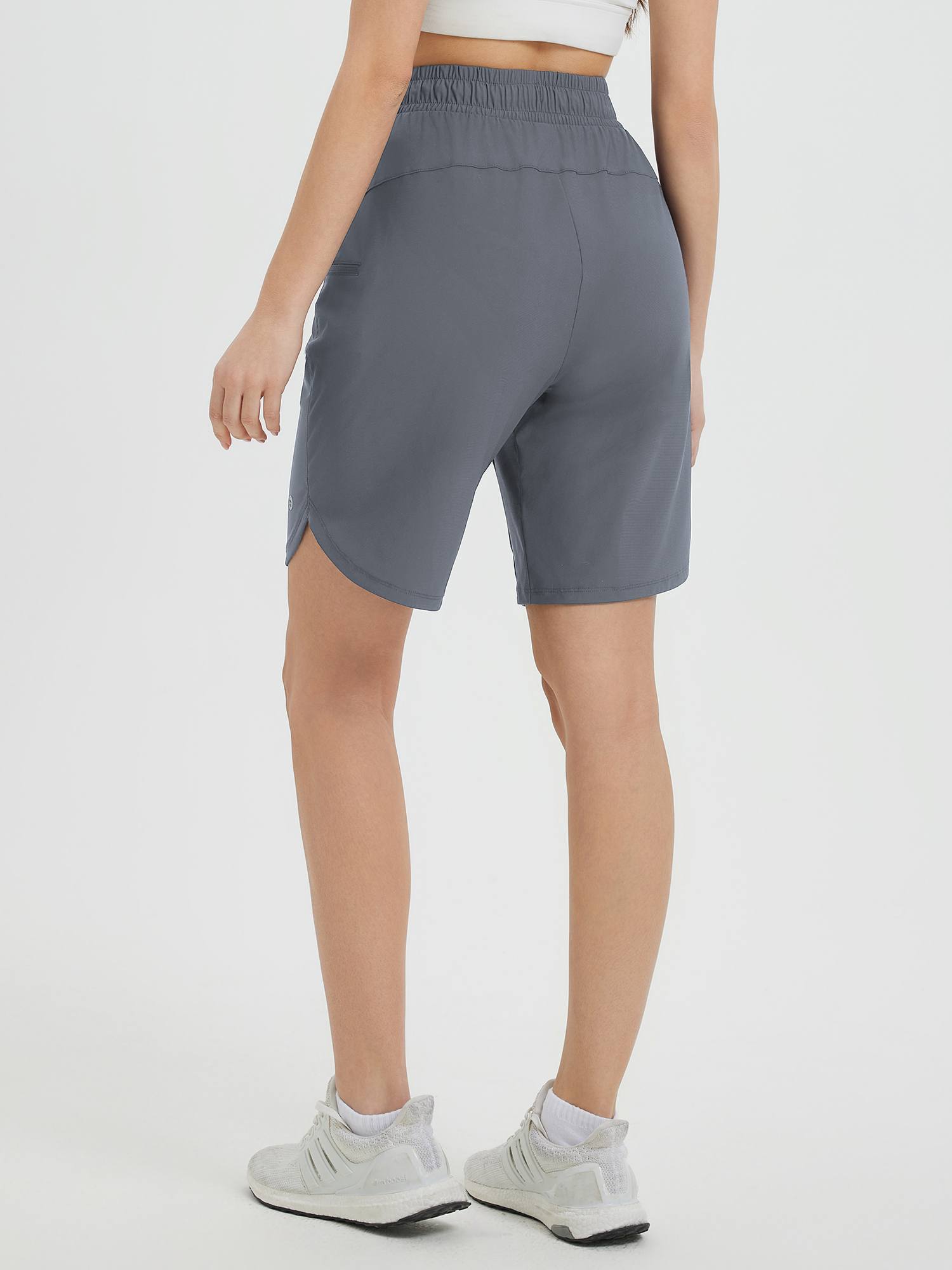 Women's grey 9-inch cycling shorts, back view, showing relaxed fit and side slit. #color_Dark Gray