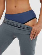 Grey cycling shorts showing blue padded bike underwear waistband. #color_Navy Blue