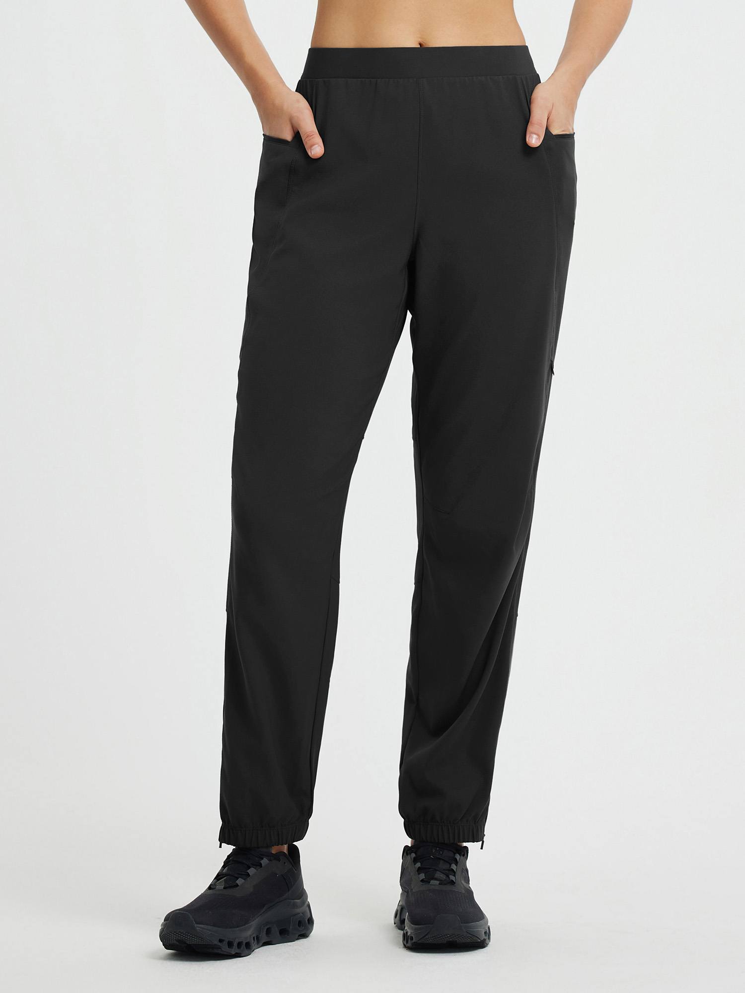 Black cycling elastic tapered pants with elastic waist and ankle zippers. #color_Black