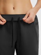 Black tapered cycling pants: elastic waistband, adjustable drawstring, side zip pocket. #color_Black