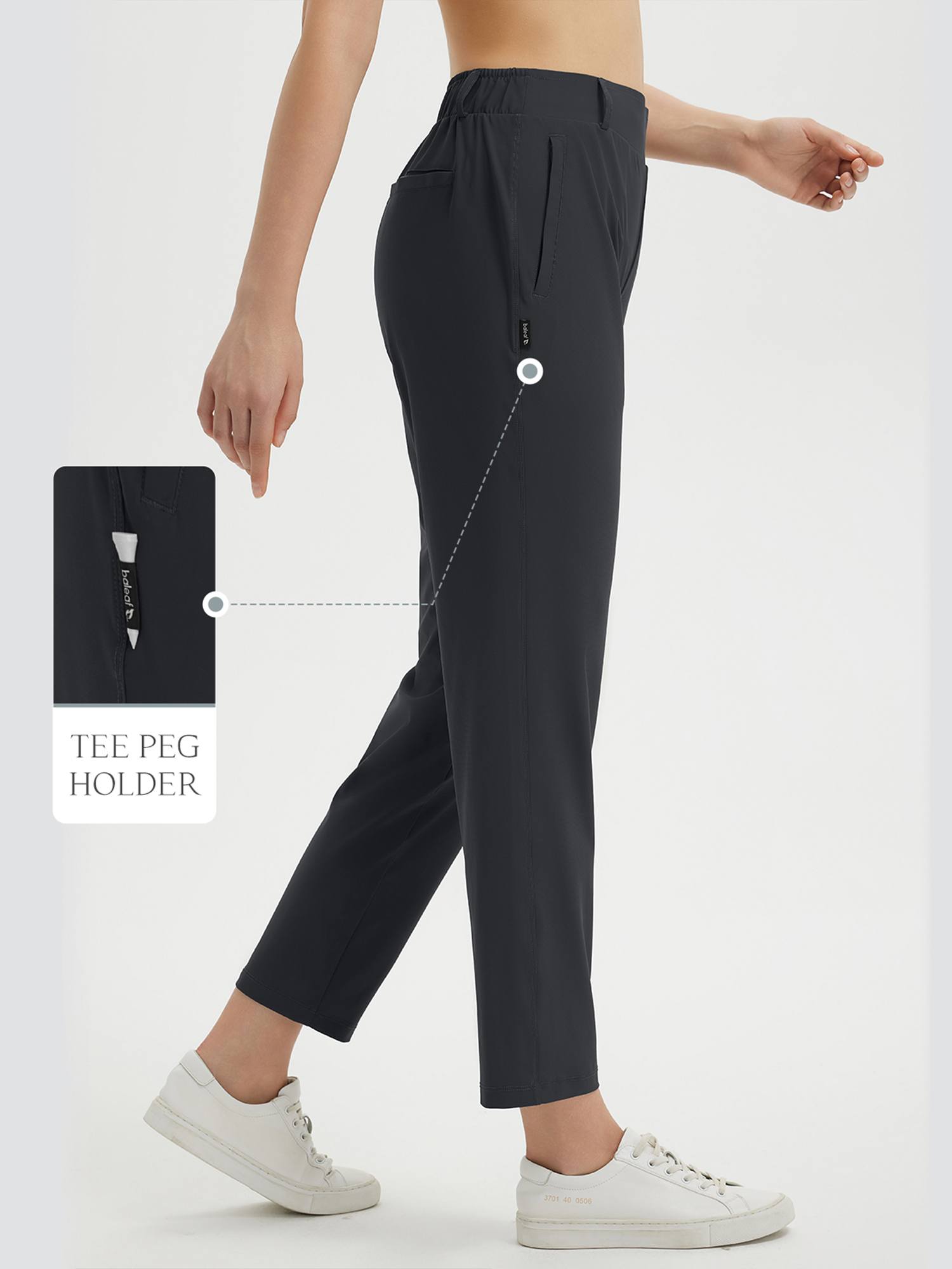 Women's dark grey 27" golf pants featuring elastic waist and built-in tee holder. #color_Black