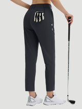 Women's dark grey 27-inch golf pants with tee holder and golf club.