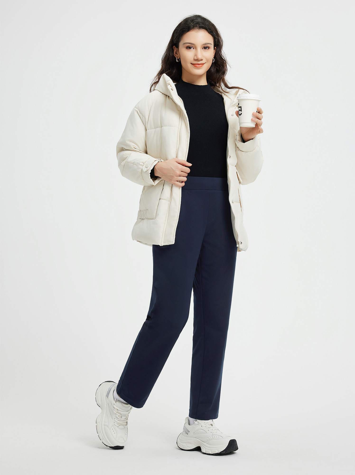 Woman in navy blue pleated fleece slim-fit golf pants and cream jacket #color_Navy Blue