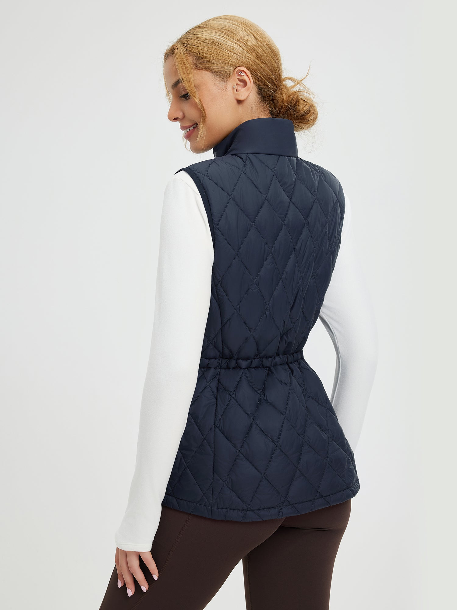 Women's navy quilted golf vest with adjustable drawstring waist. #color_Navy Blue