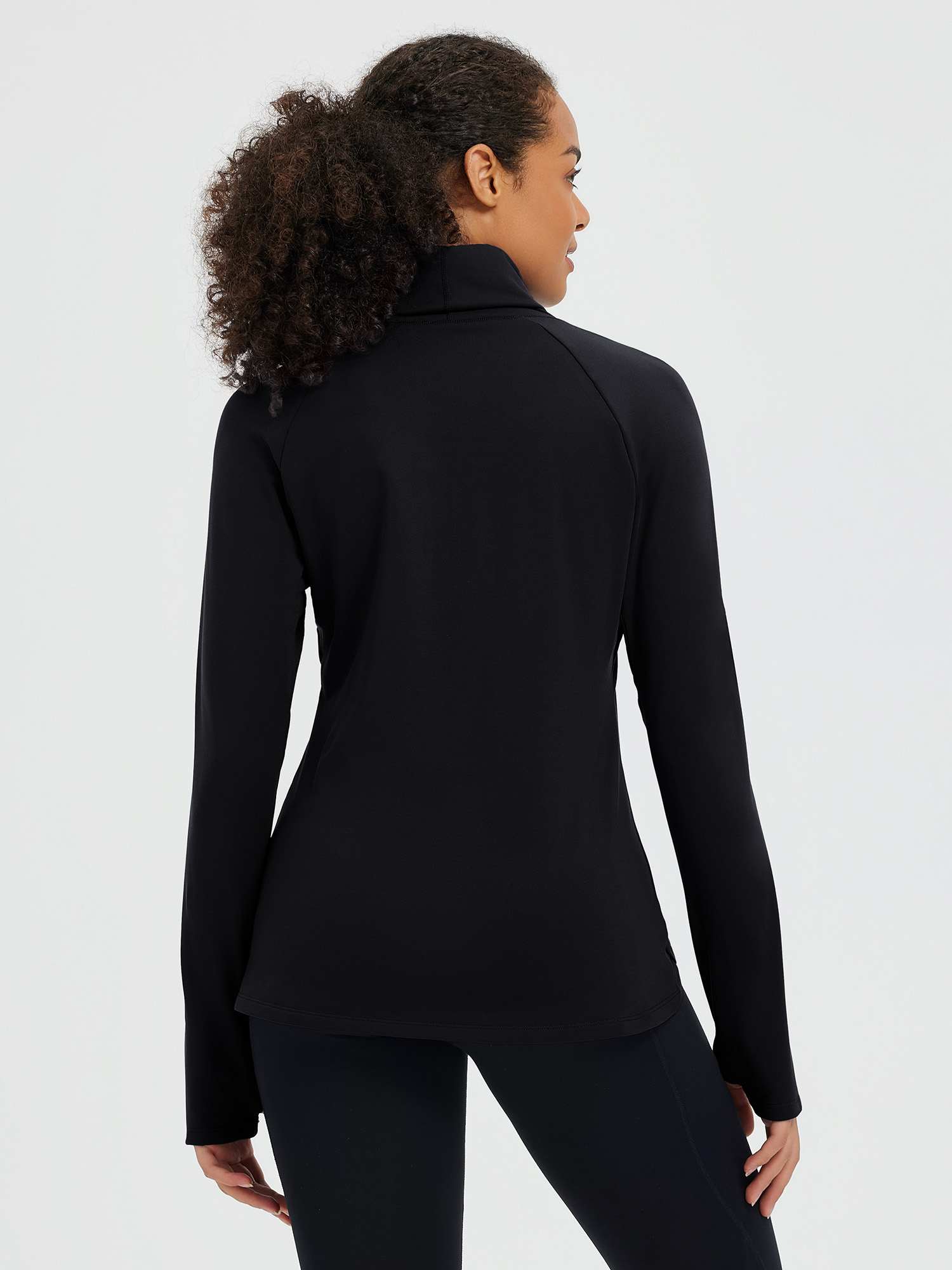 Black ski fleece base layer with convertible protective hood, back view