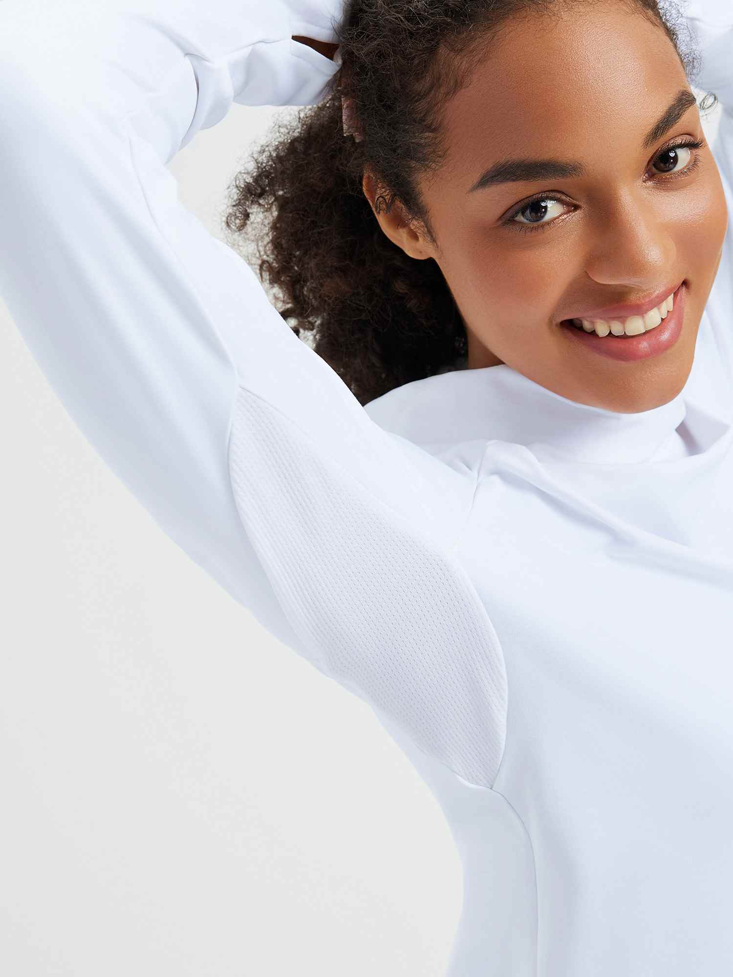White ski fleece base layer with protective hood, raglan sleeves and textured detail.