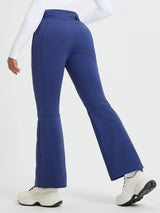 Women's flared ski softshell pants in blue with articulated knee design. #color_Navy Blue