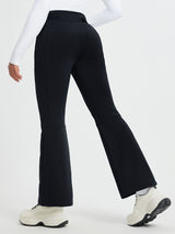 Women's black softshell ski pants with articulated knees and flared leg openings. #color_Black