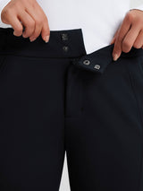 Women's dark softshell ski pants waistband detail with snap closure and adjustable buckle. #color_Black