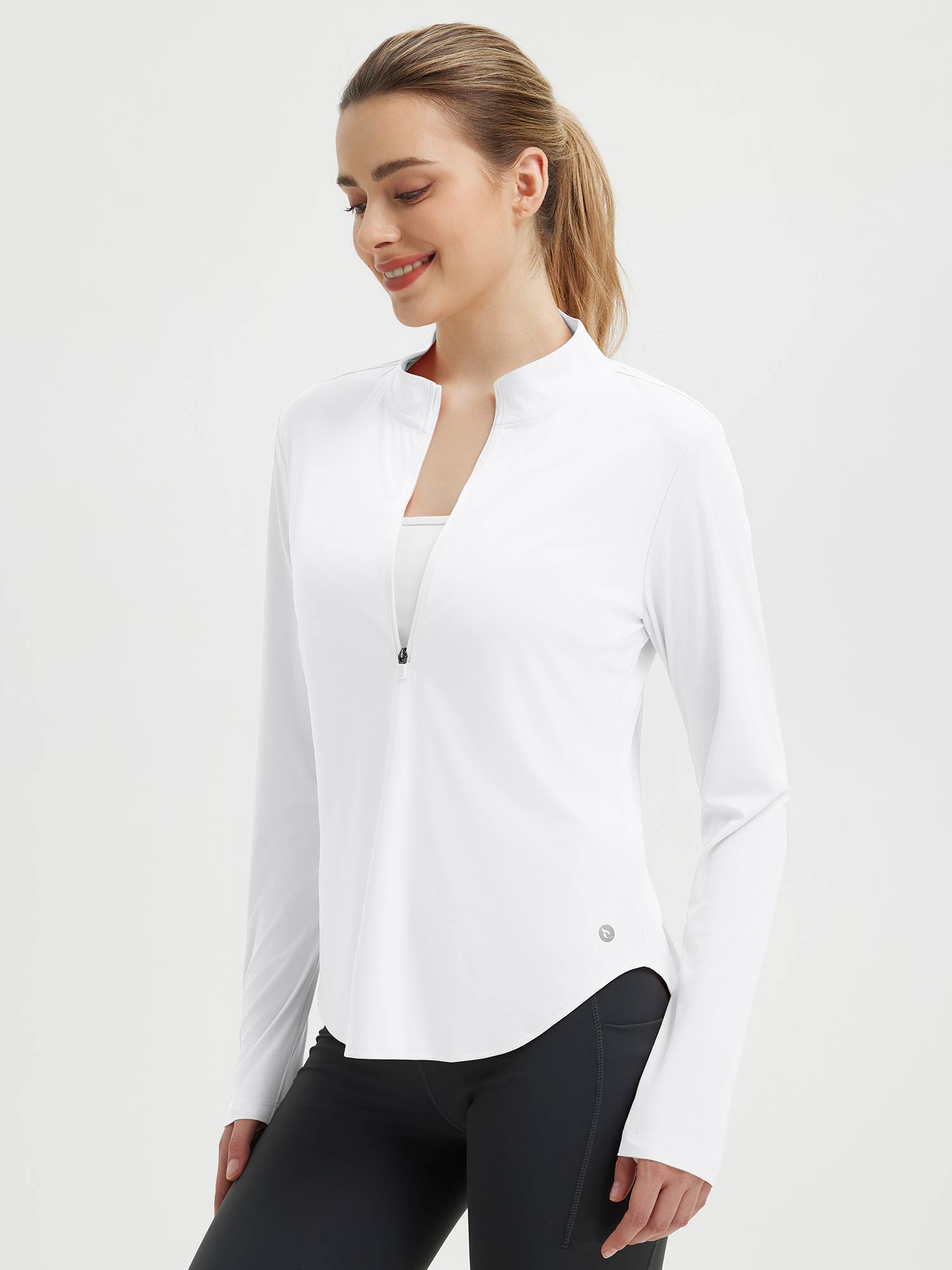 White rounded hem athletic long sleeve tee with zip neck, paired with black leggings. #color_White
