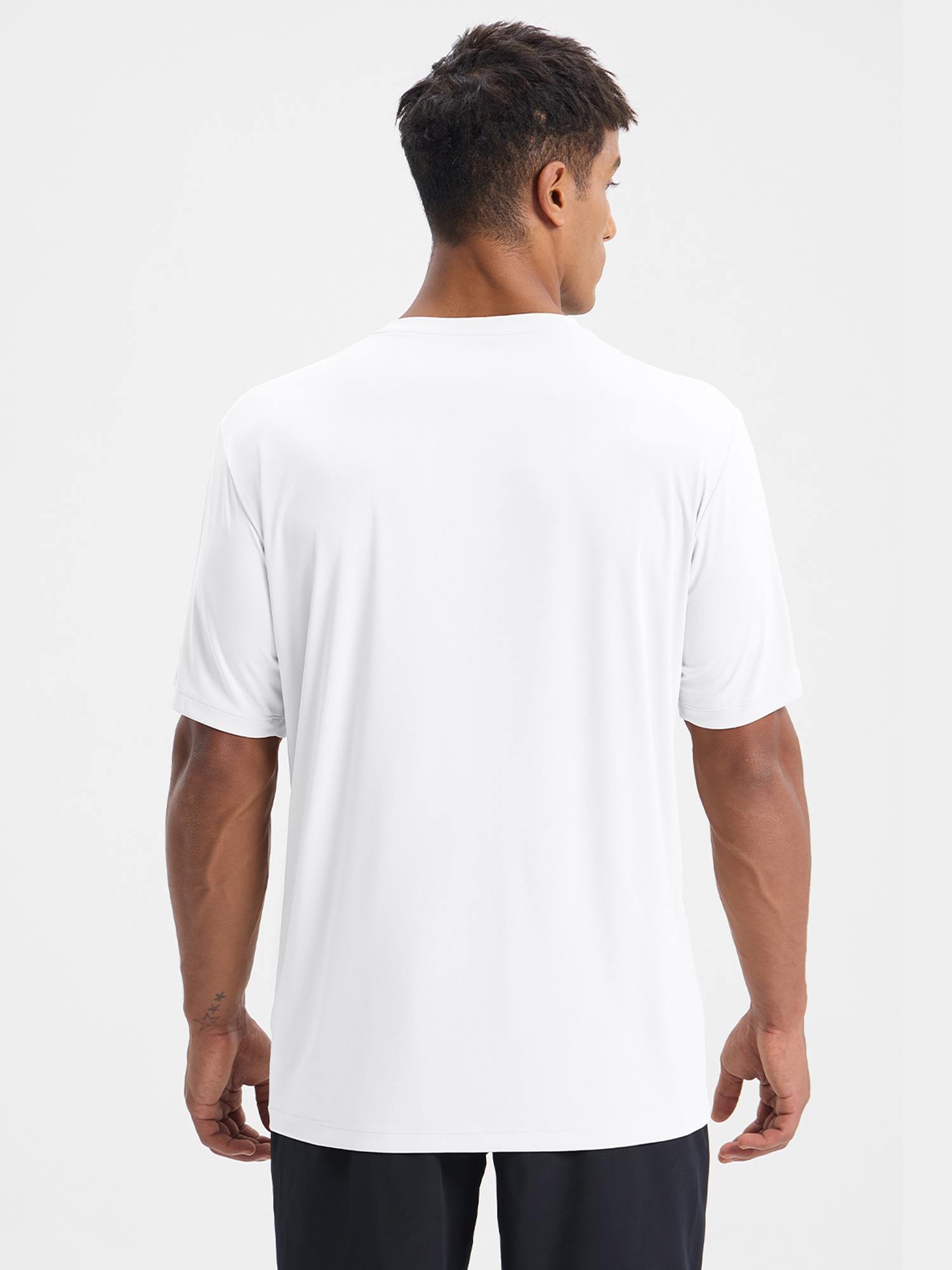 Back view of a man wearing a white short-sleeve crew neck t-shirt, ideal for outdoor activities and sports. #color_White