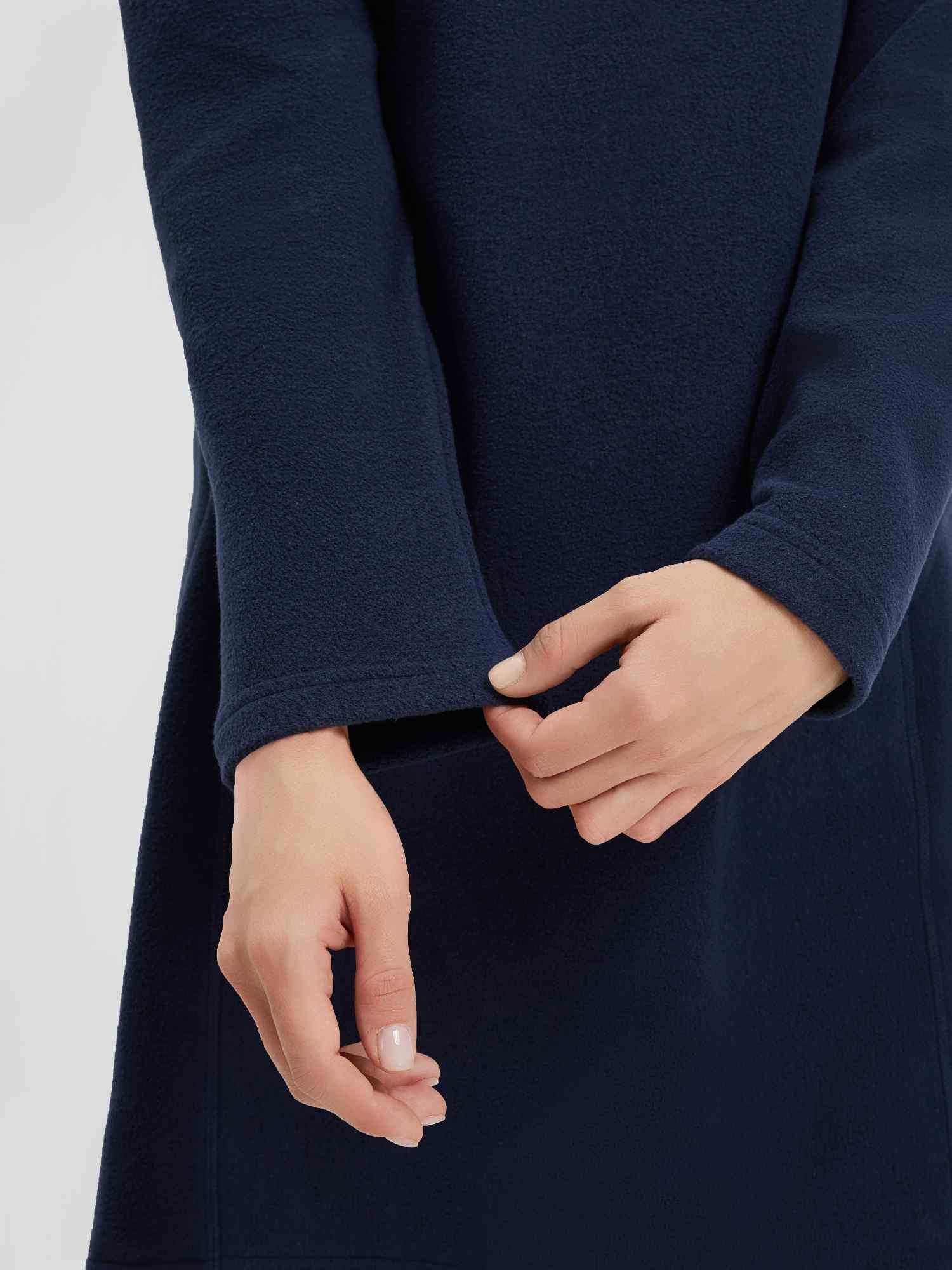 Women's navy hooded polar fleece dress: close-up of cuff and kangaroo pocket.
