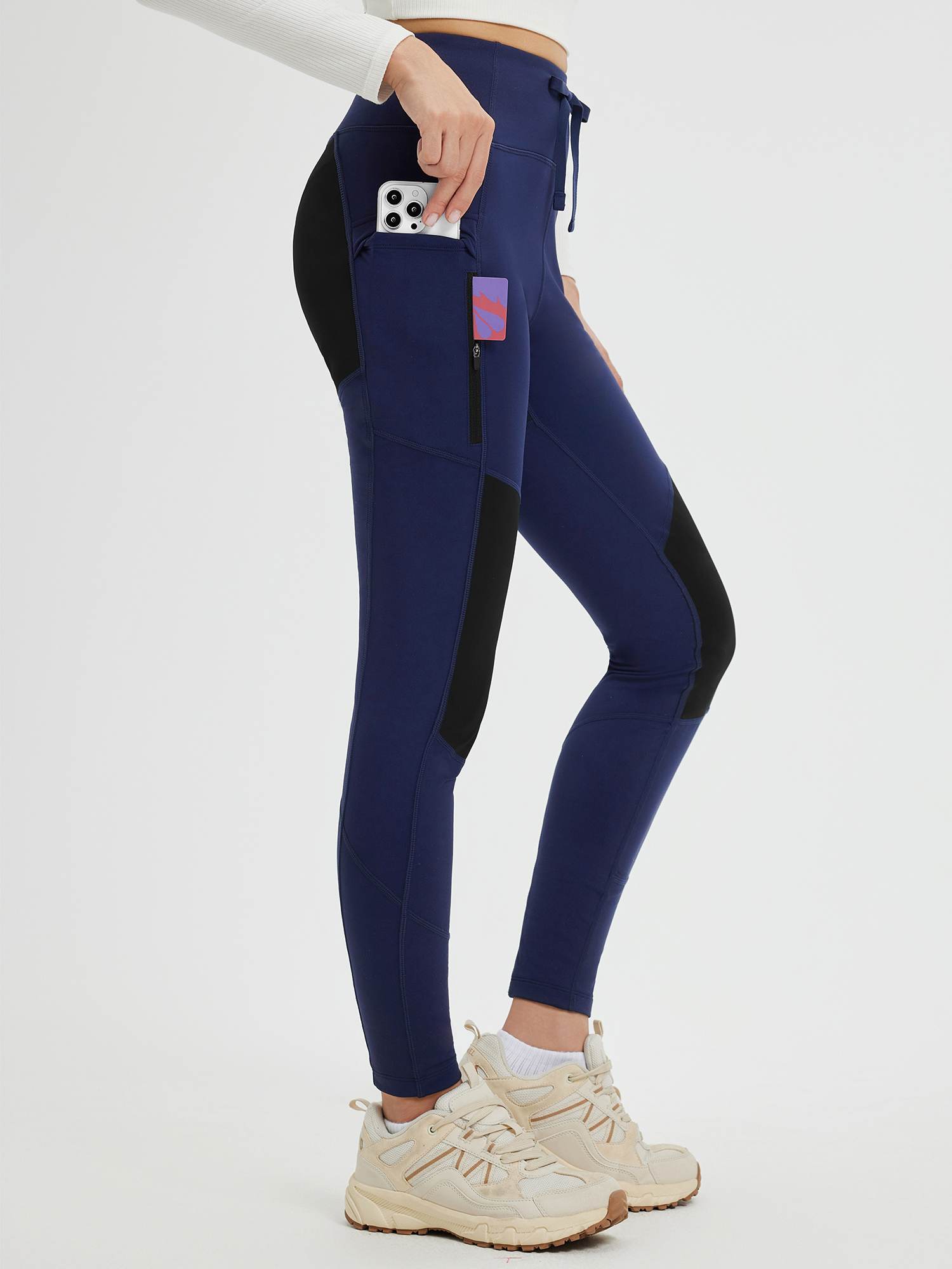 Navy blue slim-fit knit fleece outdoor pants with multiple zip pockets and drawcord. #color_Dark Blue/Black