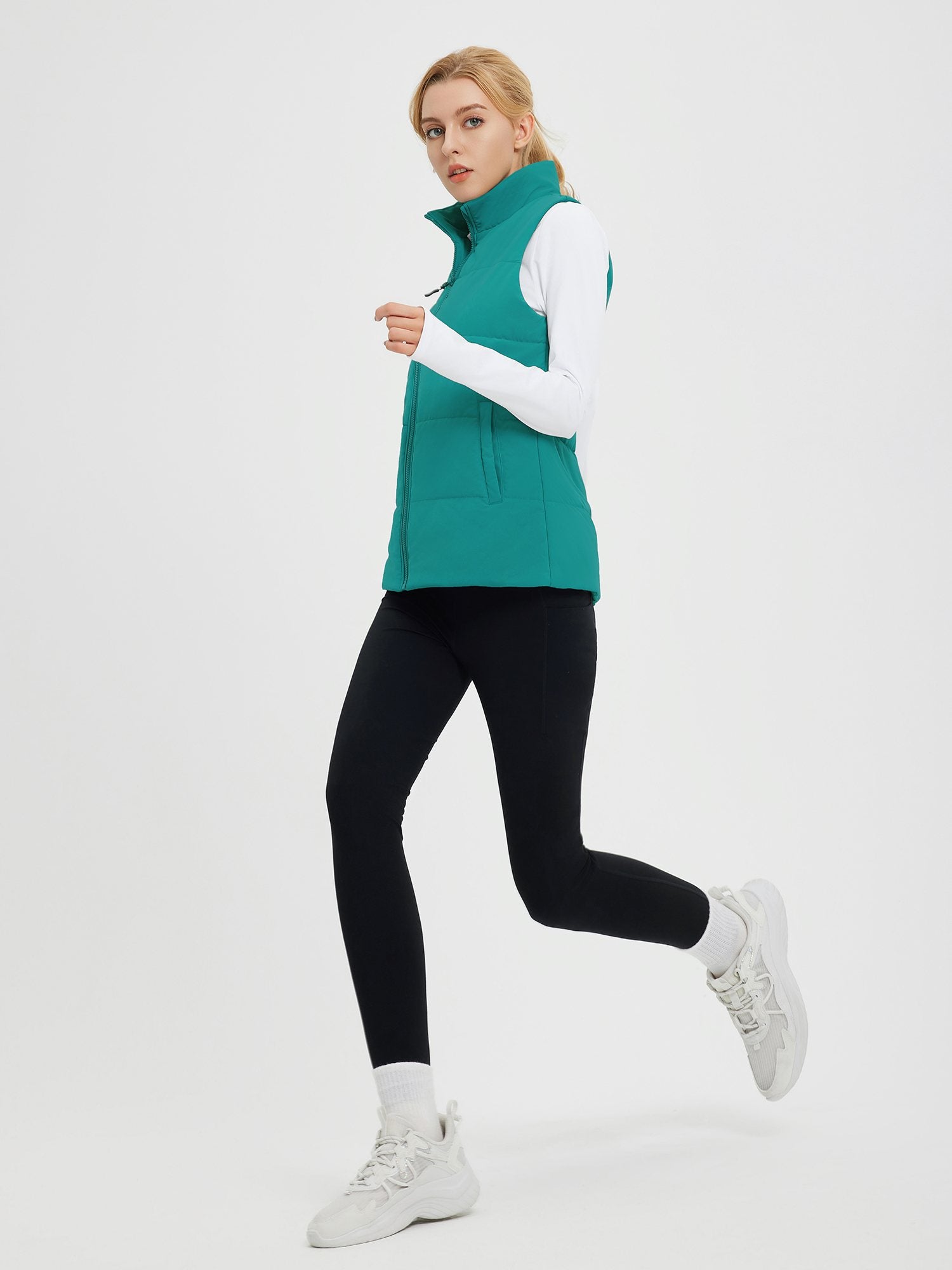 Outdoor quilted Dupont insulated vest on model in running pose. #color_Green