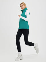 Outdoor quilted Dupont insulated vest on model in running pose. #color_Green