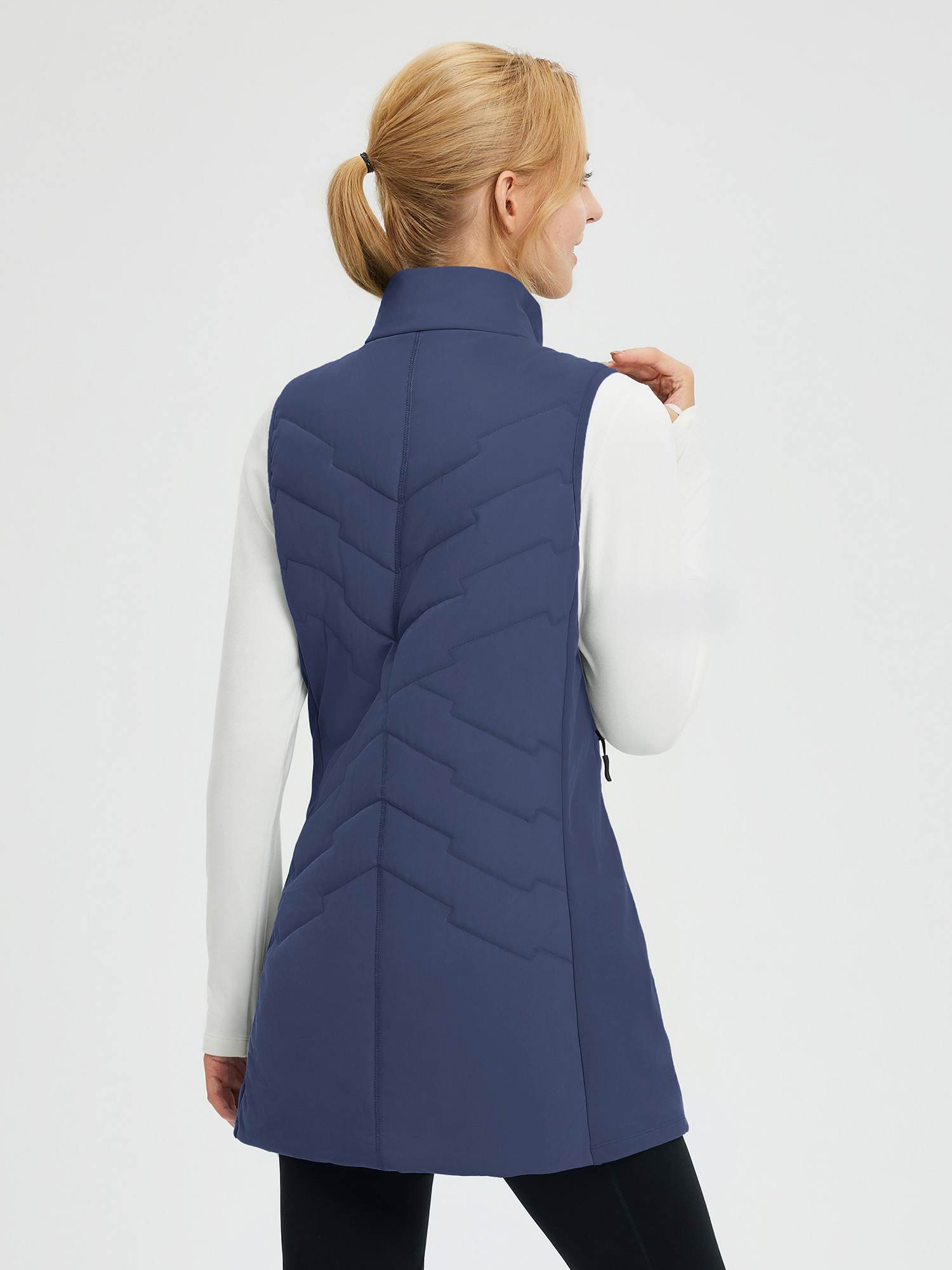 Women's navy blue woven mid-length hiking vest with quilting.